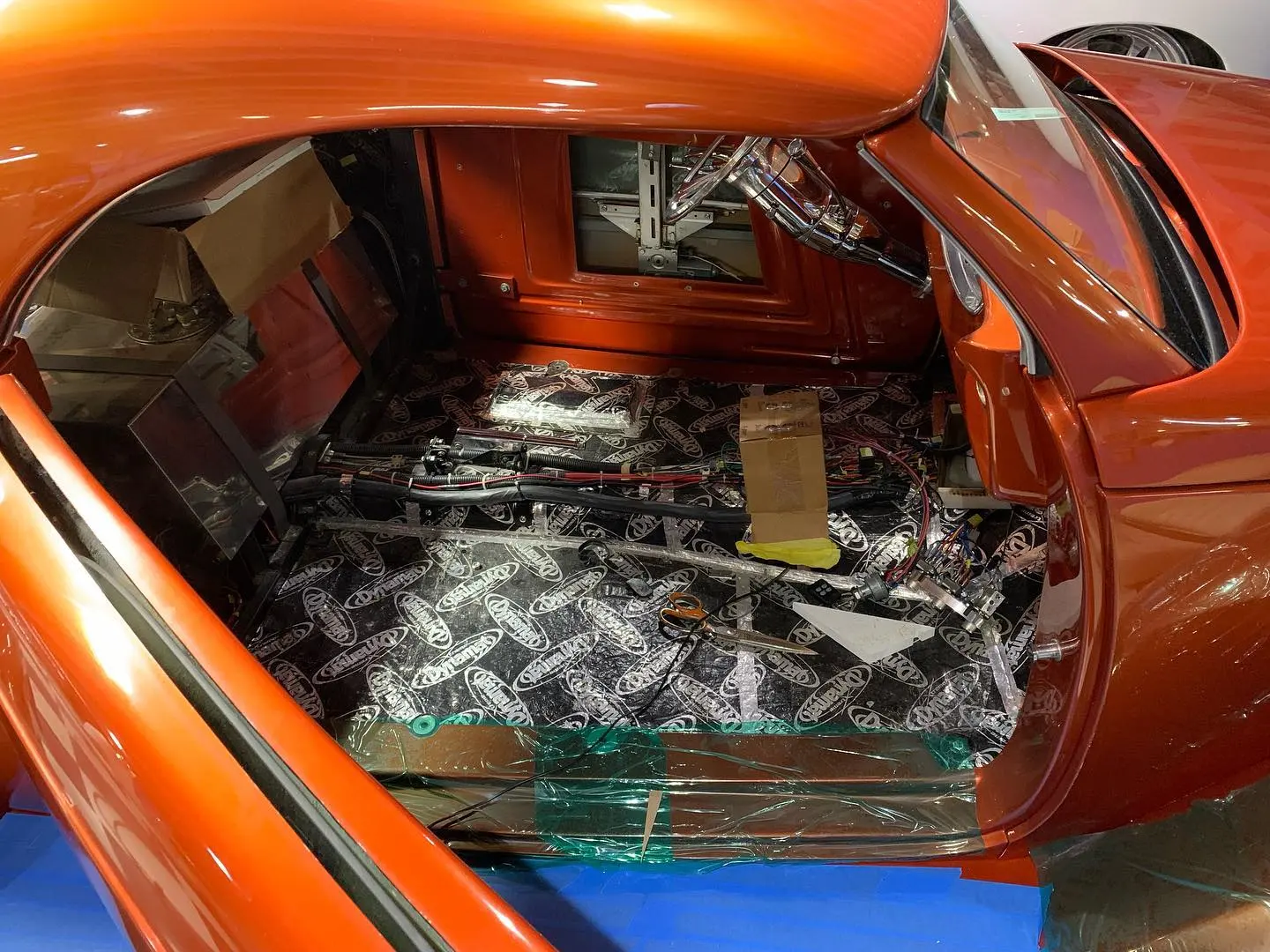 A car interior stripped to bare metal and sound deadener